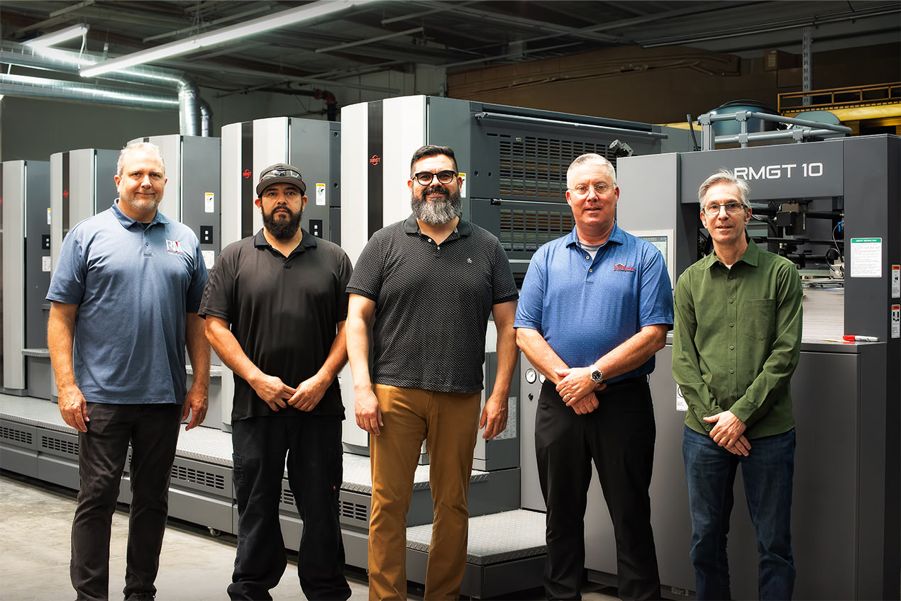 Senior Manager-Service John Ward (left) of RM Machinery joins the team at L+L Printers in front of its new RMGT 1060LX-6-CC+LD. From left to right: Ward; Lead Pressman Luis Cervantes; Operations Manager Raul Lopez; VP of Operations Andy Campbell; President Frank Scorzelli.